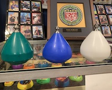 Green, blue and white delrin spintops in three different shape options